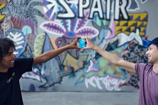 Two hands holding DKB debit card